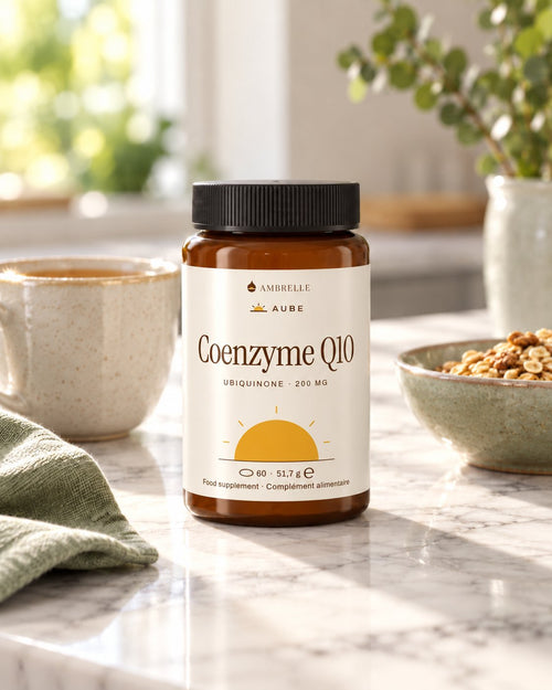 Coenzyme Q10 200 mg by AMBRELLE on a travertine bathroom shelf at sunrise, with a glass of water